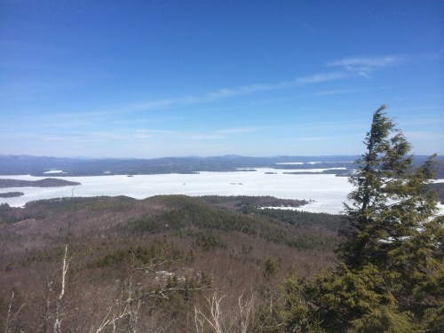 Lake Winnipesaukee still frozen with a white Mount Washington in the clear distance